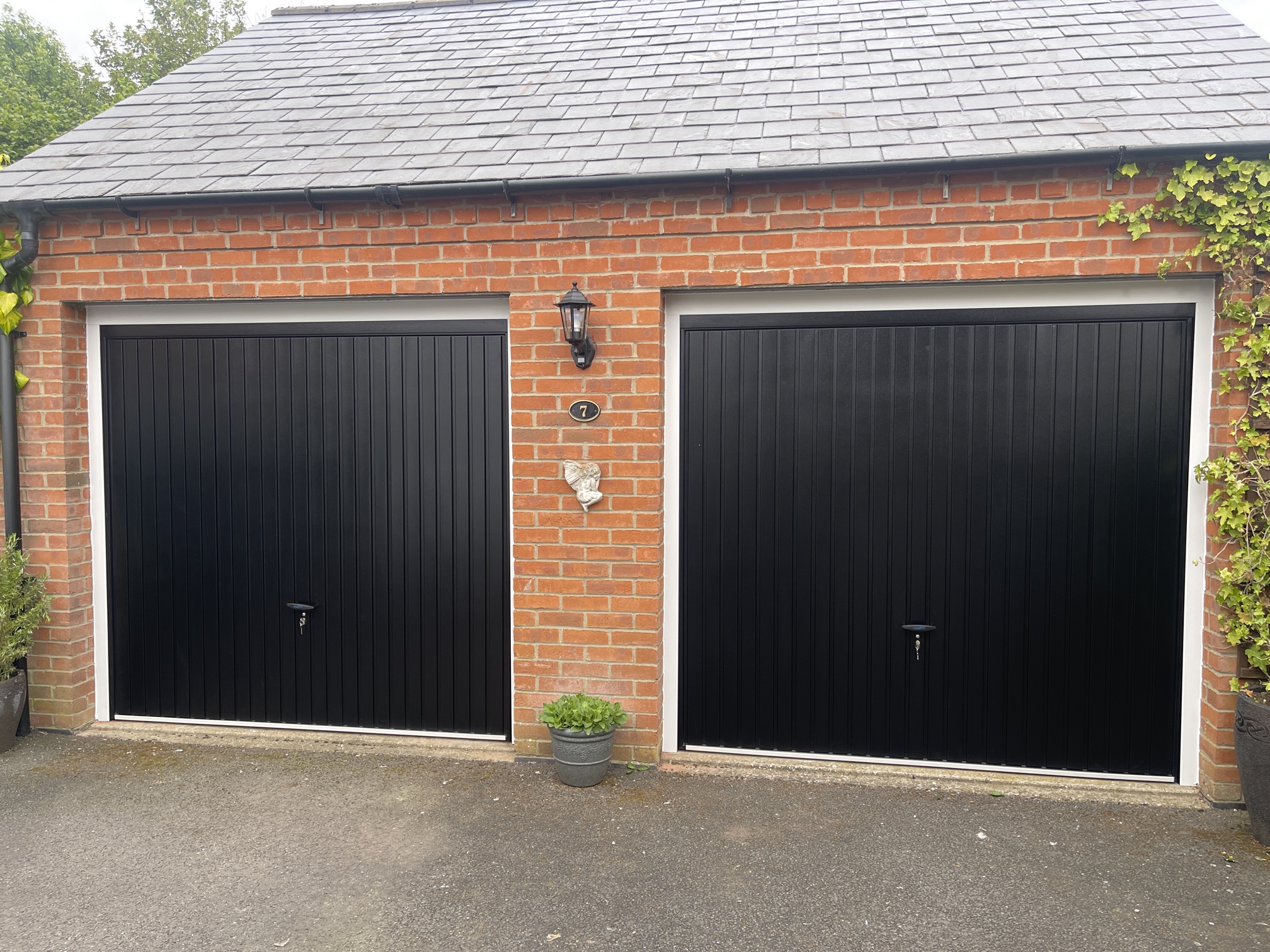 2 garage doors in black and side by side